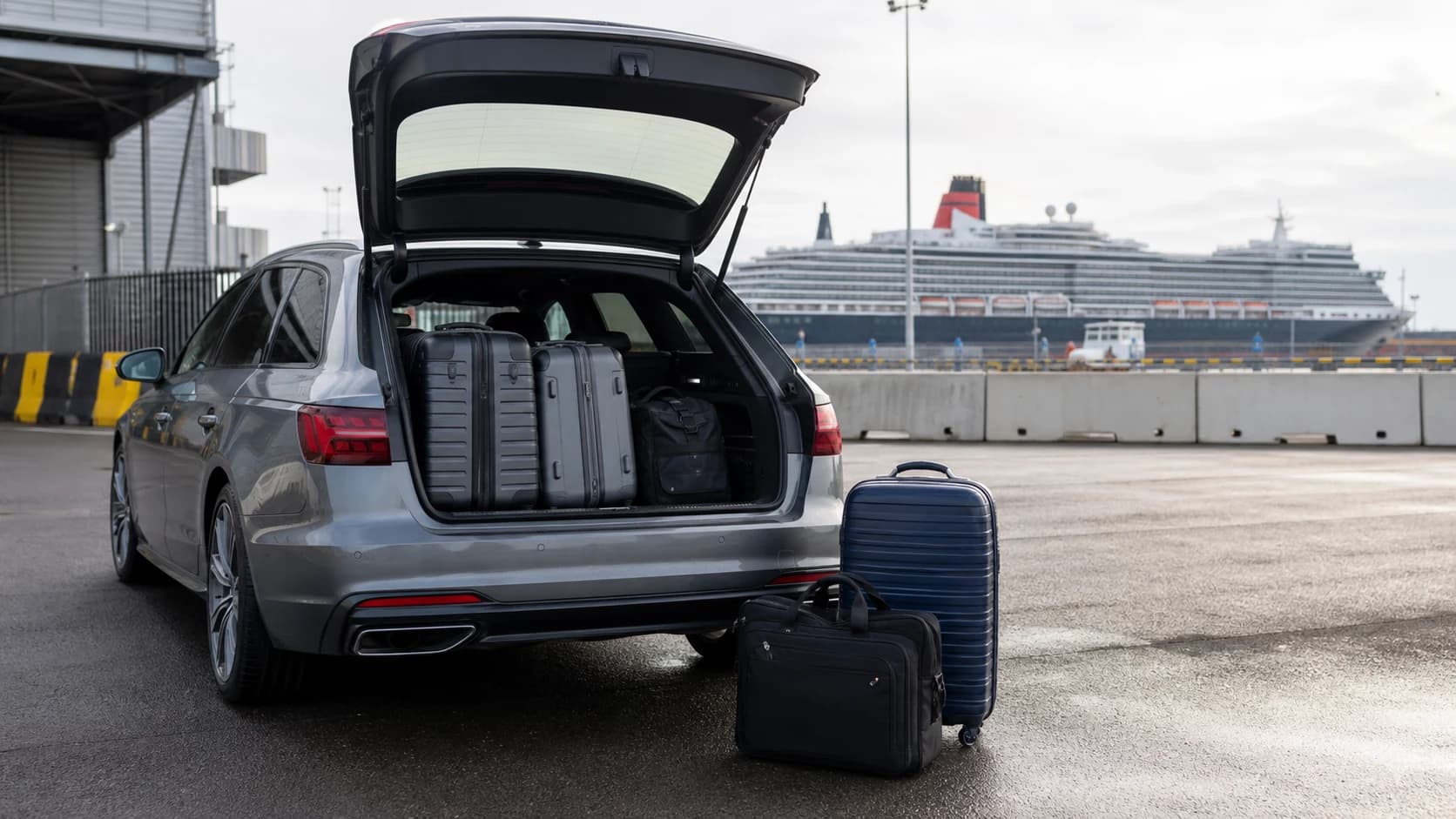 Estate car and luggage beside a cruise terminal