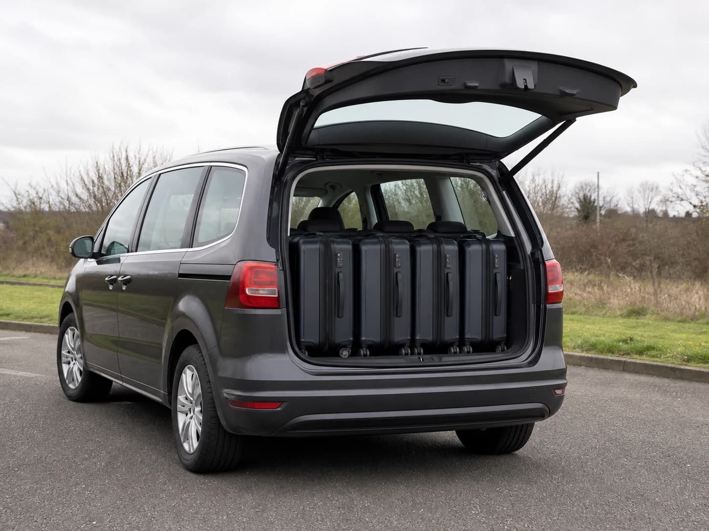 People carrier with four suitcases in the luggage compartment